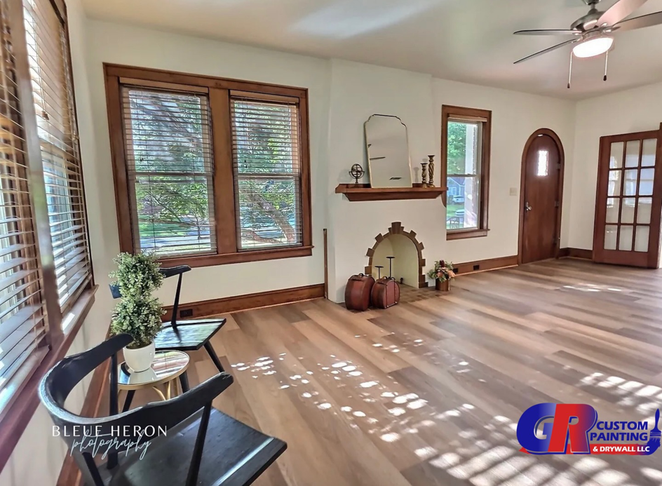 A renovated living room featuring a fireplace, new flooring, and fresh paint by GR Custom Painting & Drywall LLC in Shreveport, LA.