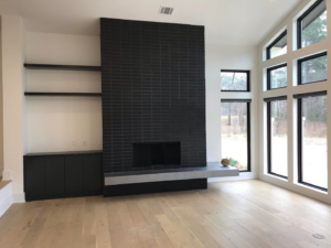 Custom fireplace tile and built-in shelving installation by Berry Builders, L.L.C. in Shreveport, LA.