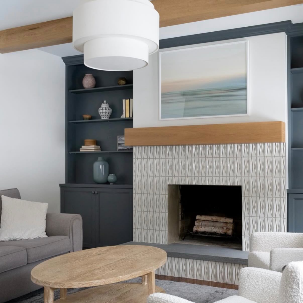 Modern fireplace tiling and custom built-in shelves with exposed beams by Brentwood Builders Inc. in Lancaster, PA.