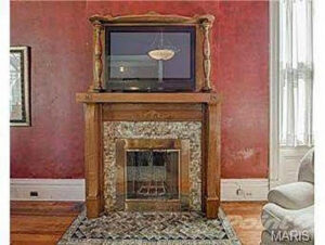 A detailed view of a fireplace with a television mounted above it in a living room, a service provided by Major League Handyman and Remodeling in St. Louis, MO.
