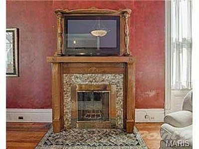 A detailed view of a fireplace with a television mounted above it in a living room, a service provided by Major League Handyman and Remodeling in St. Louis, MO.