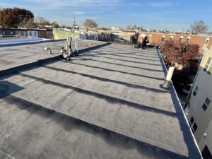New flat roof installation on an urban building, showcasing general contractor work by MCG General Contractor in Philadelphia, PA.