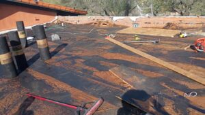 Roofing materials and tools laid out for a flat roof repair by Mayitos roofing LLC in Tucson, AZ.