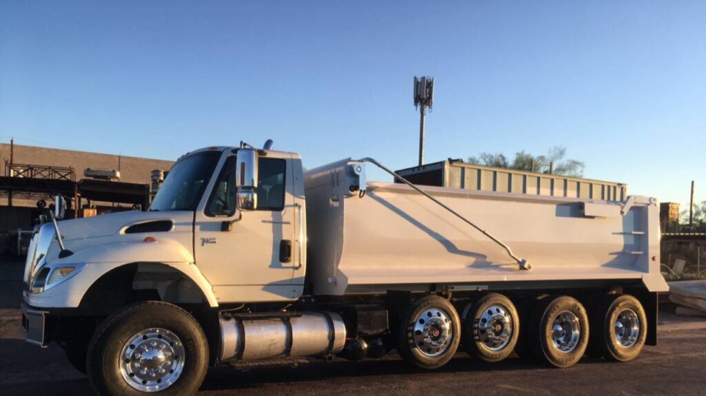 A flatbed truck carrying a concrete saw and other specialized equipment for AZ Saw & Remove LLC in Gilbert, AZ.