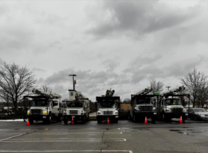 A fleet of professional tree service trucks parked, ready for work by Malec Tree Service in Harrisville, RI