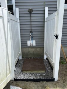 Custom floating shelves installed on a wall, holding potted plants, by Woodbine Repair & Remodeling in Jamestown, RI.