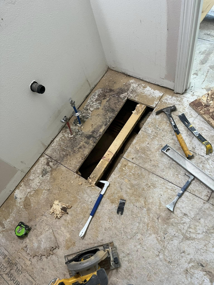 Floor demolition and repair tools on a subfloor, showing a handyman project in progress by Worths handyman services in Wasilla, AK.