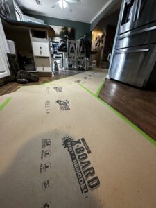 Floor protected with paper during remodeling preparation in a kitchen by KG Handyman & Remodeling in Vilonia, AR.
