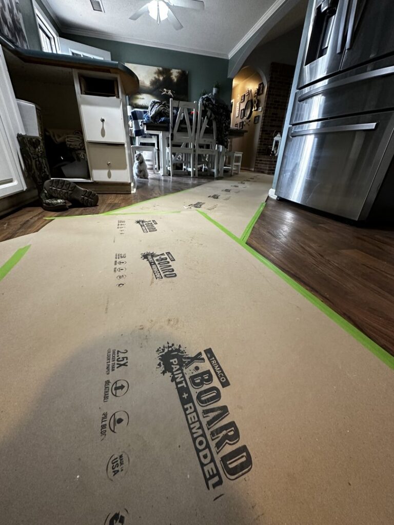 Floor protected with paper during remodeling preparation in a kitchen by KG Handyman & Remodeling in Vilonia, AR.
