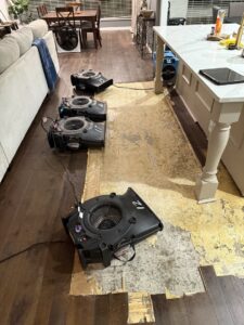 Wooden floor removed with air movers for water damage restoration by Coyote Restoration in North Richland Hills, TX.