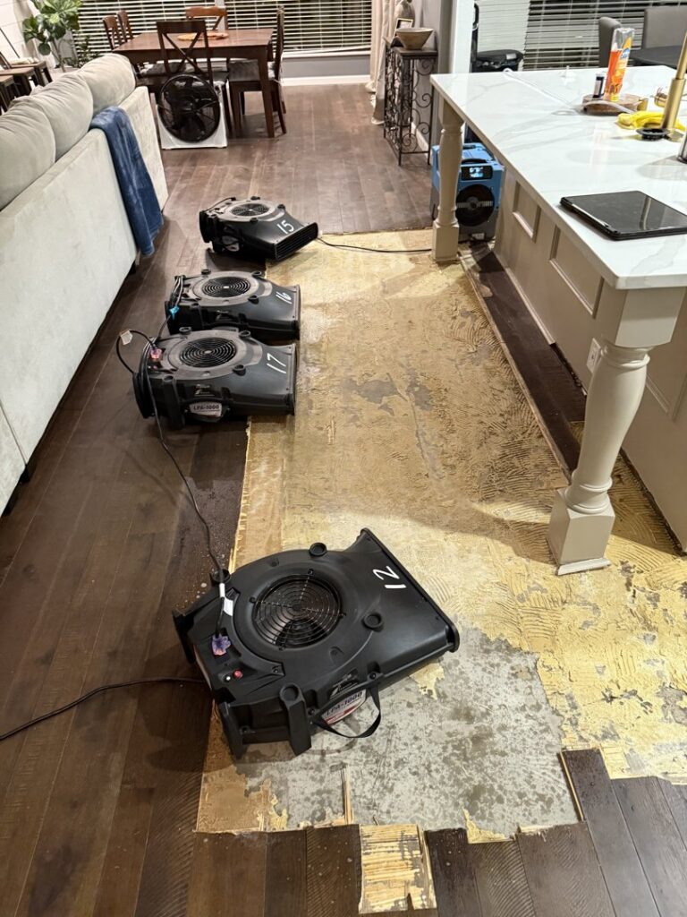 Wooden floor removed with air movers for water damage restoration by Coyote Restoration in North Richland Hills, TX.