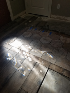 Floor tile installation in progress with hexagonal and plank tiles by Clayton Family Tile, LLC in Chandler, AZ