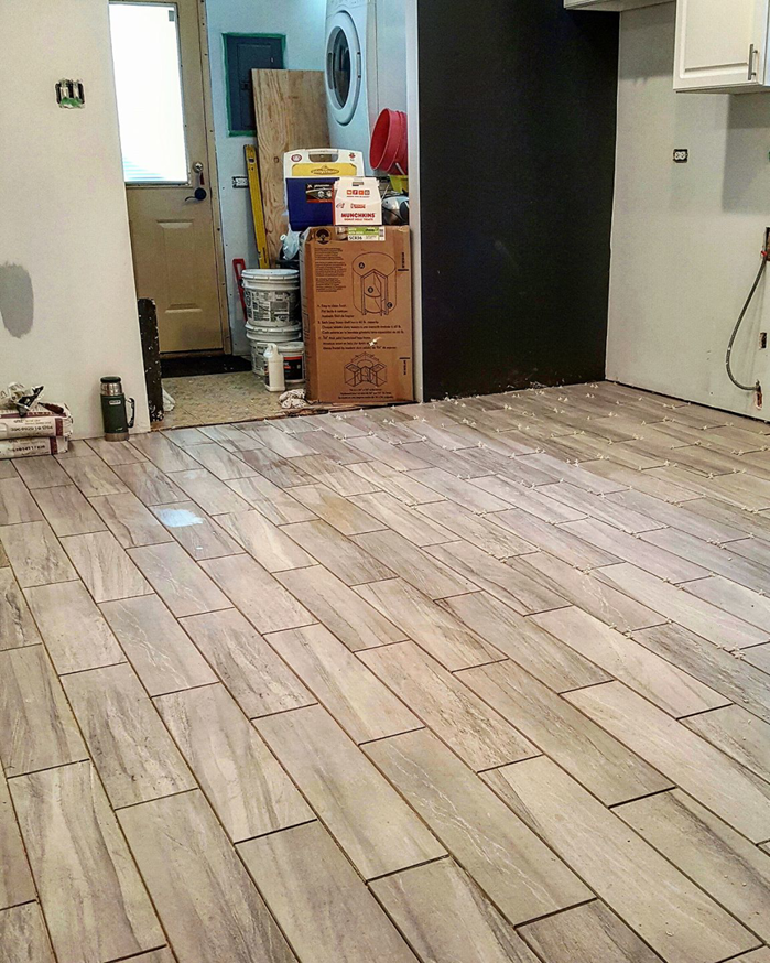 Floor tile installation in progress in a residential kitchen by F&S Construction Group in Chicago, IL.