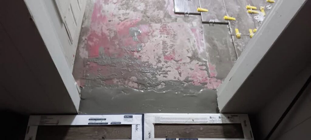 Floor tile installation in progress with mortar and spacers, demonstrating flooring services by Joel's flooring & Handyman services in Roy, UT.