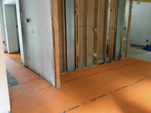 Floor prepared with Schluter Ditra matting for tile installation during a renovation by Jay's Construction in Cincinnati, OH.