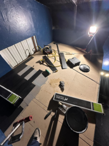 An indoor room showing flooring installation in progress with tools and materials by Ambition Services Llc in Greeley, CO.