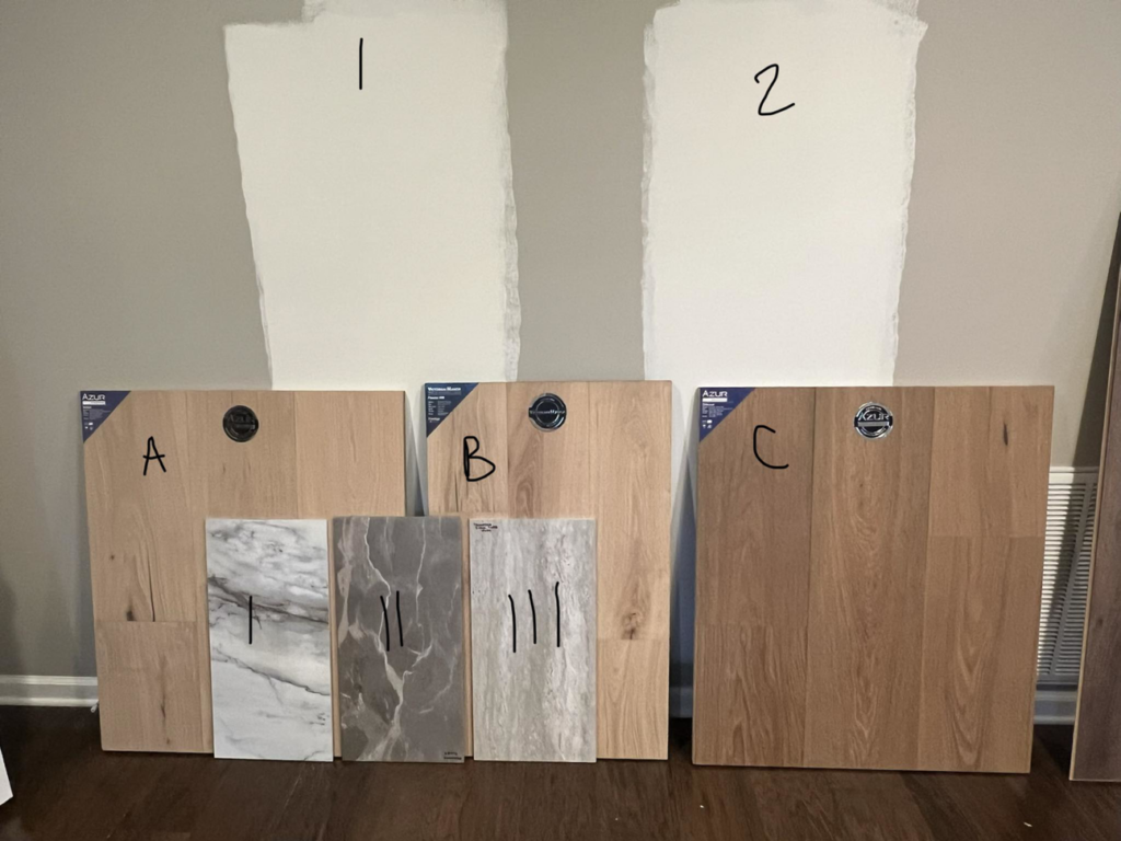Various flooring and paint samples displayed on a wall for a renovation project by Kirkland Residential & Property Solutions in Clarksville, TN