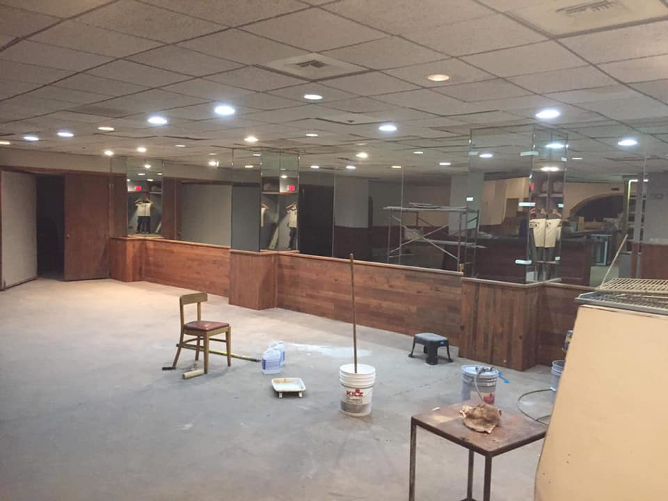 A close-up of a newly installed flooring transition between wood and tile by Landon and David handyman in Wichita, KS.