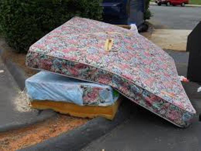A floral mattress and box spring placed curbside for removal by Omaha junk Removal and Hauling Service in Omaha, NE.