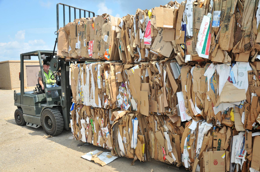 A worker operating a forklift to move baled cardboard at Nevada Recycling and Salvage in Reno, NV.