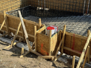 Wooden formwork, rebar, and pipes during construction by Stealth Civil Contracting in Austin, TX.