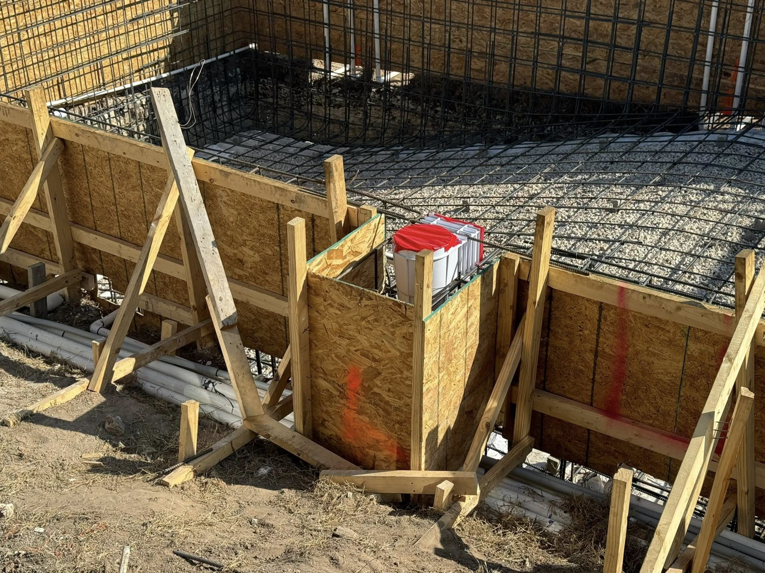 Wooden formwork, rebar, and pipes during construction by Stealth Civil Contracting in Austin, TX.