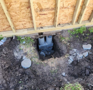 Foundation piers exposed during excavation for house repair by Complete Foundation Repairs in Corpus Christi, TX.