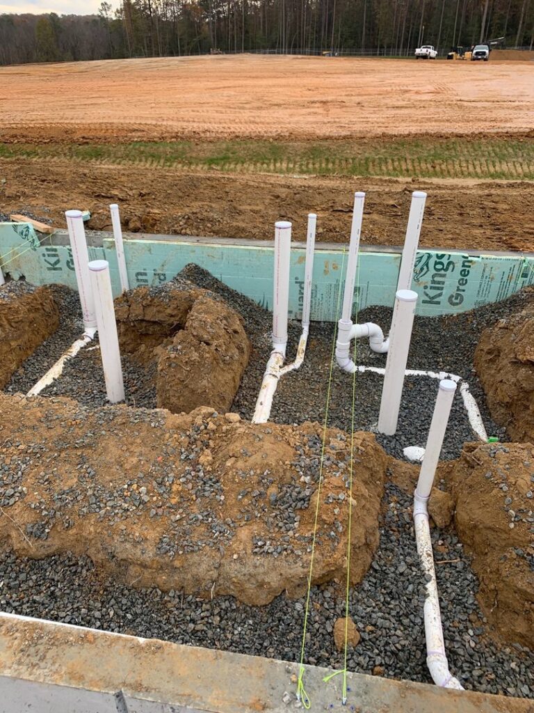 Foundation plumbing installation with pipes laid in trenches by Snyder Solutions LLC in Richmond, VA