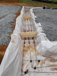 Rebar and plastic sheeting installed for a new foundation by B & L Builders in Jonesborough, TN