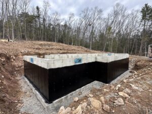 A foundation waterproofing project in a winter setting by ProSeal Waterproofing in Naugatuck, CT.