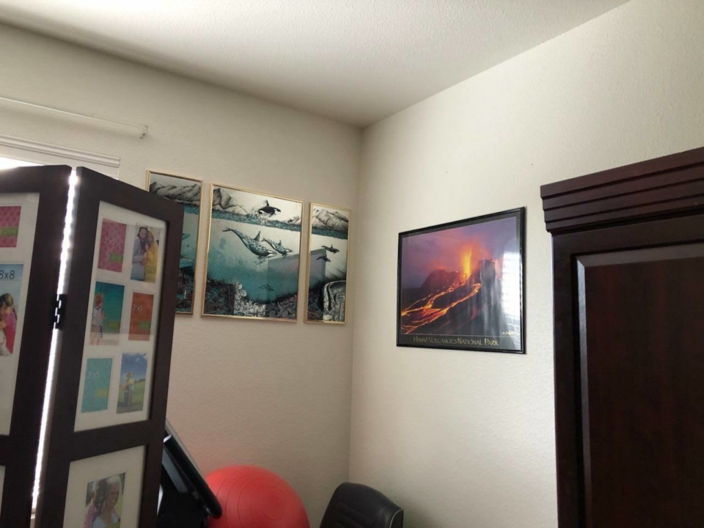 Expert hanging of framed art and a poster in a room corner by Rick's Handyman in Cheyenne, WY.