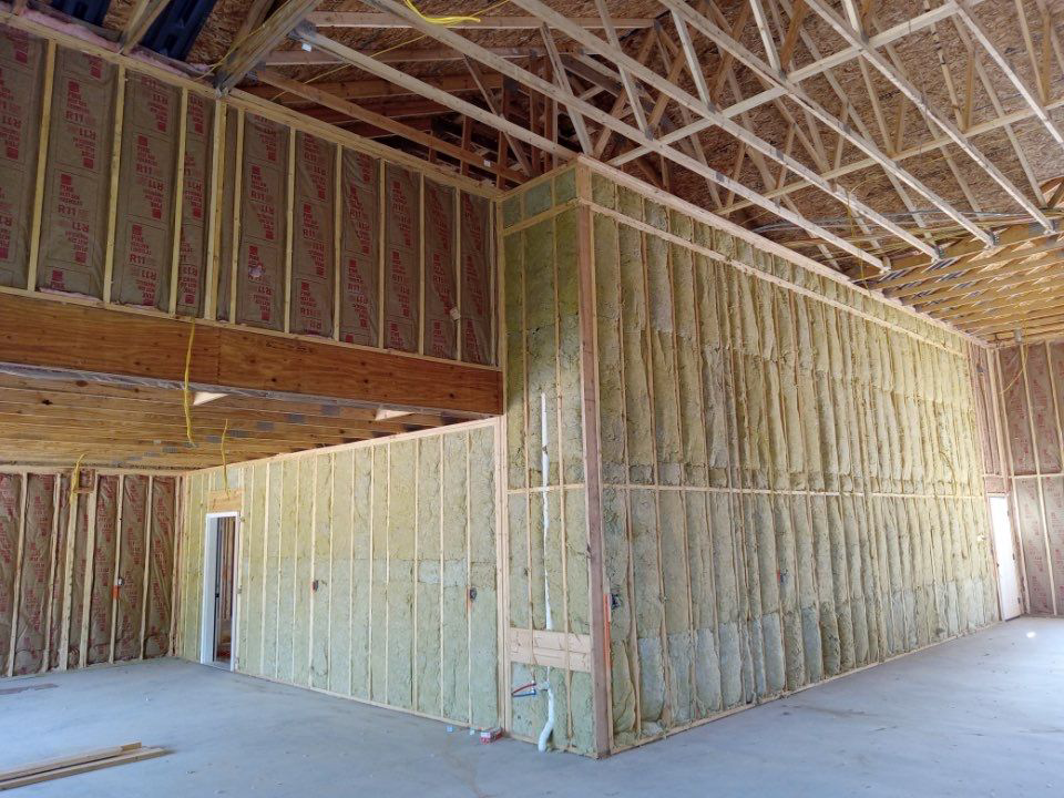 A framed building interior showing wall insulation installed by Prairie Insulation LLC in Springfield, IL.