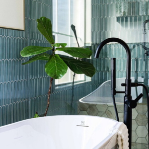 A newly installed freestanding bathtub with a modern black faucet by Rockin' Remodeling LLC in Austin, TX