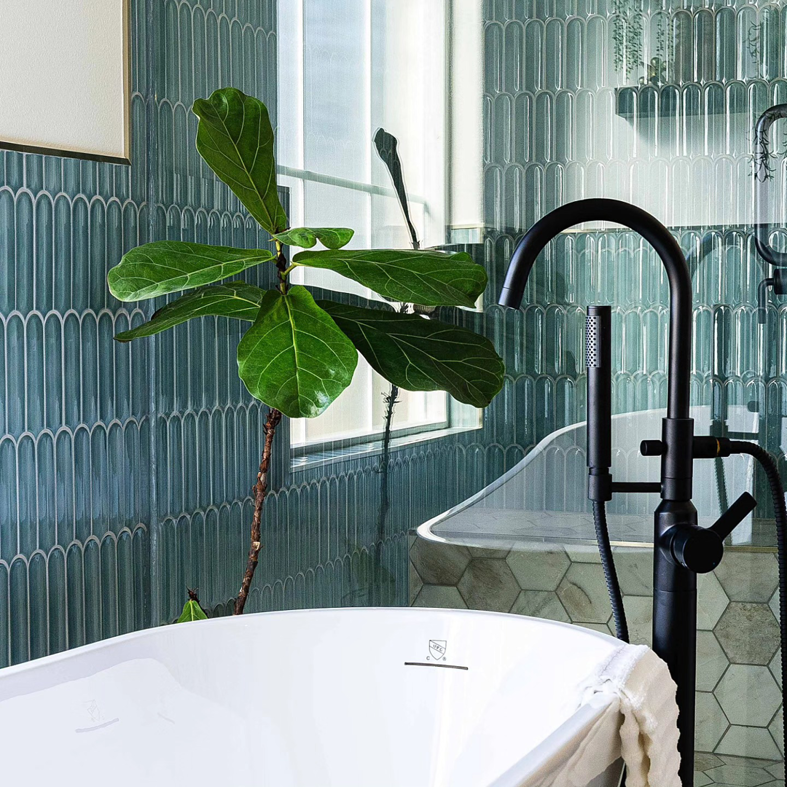 A newly installed freestanding bathtub with a modern black faucet by Rockin' Remodeling LLC in Austin, TX