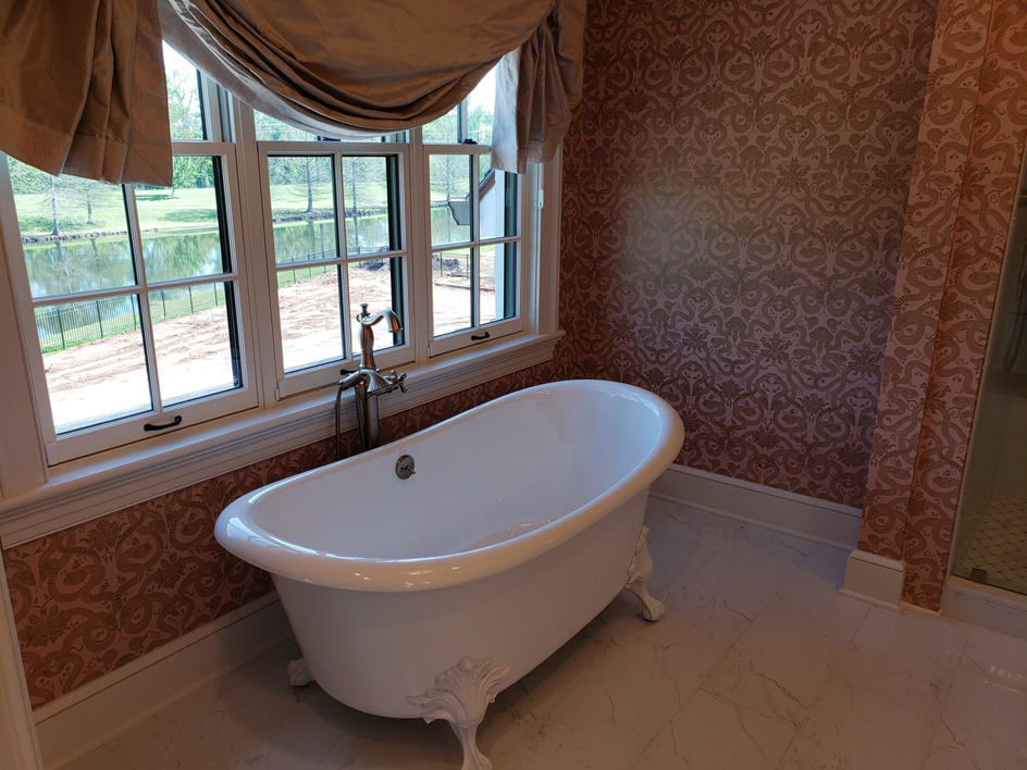 A freestanding clawfoot tub installed in a renovated bathroom by Kenneth C. Bergeron, Architect in Pollock, LA.