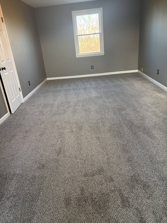 A freshly carpeted room with newly painted gray walls by DC Home Solutions in Atlanta, GA.