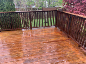 A freshly cleaned or stained wooden deck with railings, showcasing outdoor maintenance by Humphrey's Helping Hands in Clarksville, TN.