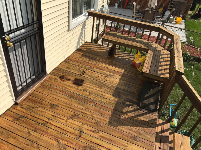 A freshly cleaned and well-maintained wooden deck, a service provided by Applied Pressure LLC in Detroit, MI.