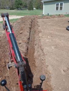 A freshly dug trench for excavation services by Todd's Mini-Tractor/Backhoe Services in Appleton, WI.