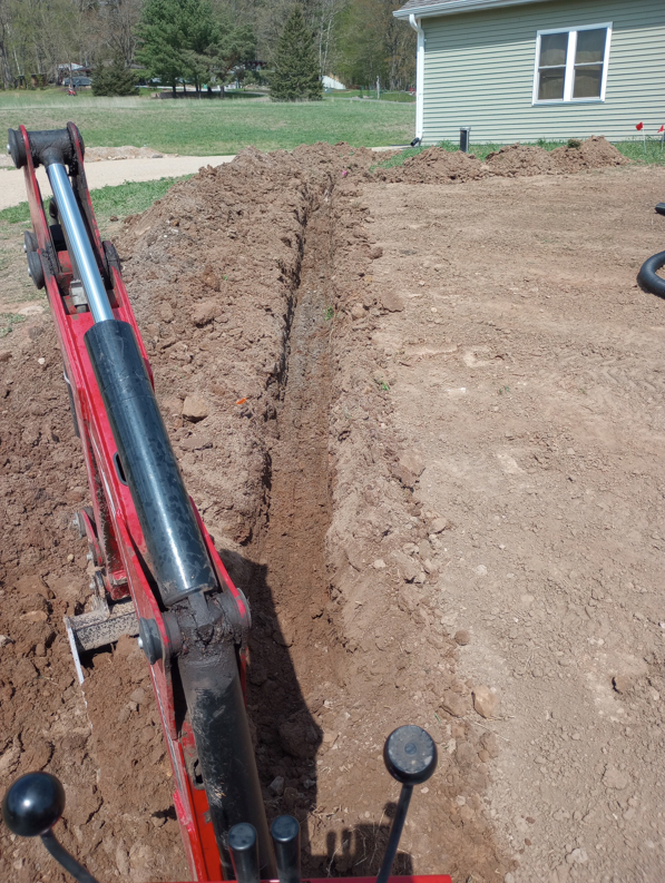 A freshly dug trench for excavation services by Todd's Mini-Tractor/Backhoe Services in Appleton, WI.