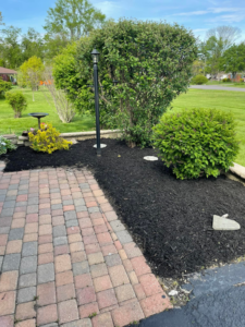 A freshly mulched garden bed and paved walkway completed by Barreto's Family Construction Company in Dayton, OH.