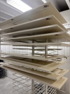Freshly painted cabinet doors stacked on a drying rack, part of a handyman cabinet painting service by Randy Overacre Painting Company in Virginia Beach, VA.