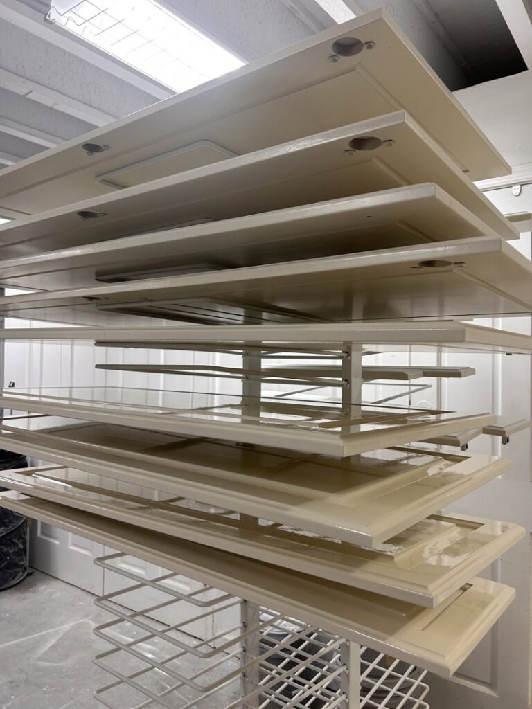 Freshly painted cabinet doors stacked on a drying rack, part of a handyman cabinet painting service by Randy Overacre Painting Company in Virginia Beach, VA.