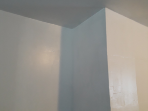 A freshly painted corner of a room, showing completed drywall work by D&B Drywall in Canton, OH.