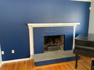 A freshly painted blue fireplace and walls in a living room by Connecticut Painting Group, Inc in North Haven, CT