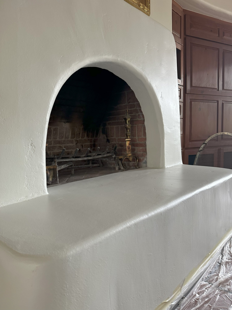 A freshly painted white fireplace completed by Paint Co in Canyon Lake, CA