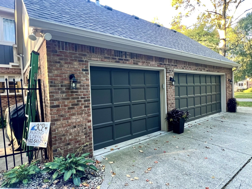 Freshly painted dark garage doors by KP Painting, a handyman service in Captain Cook, HI.