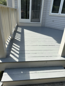 A freshly painted grey outdoor deck and stairs completed by SGT. Handyman services RI in Downtown Pawtucket, RI
