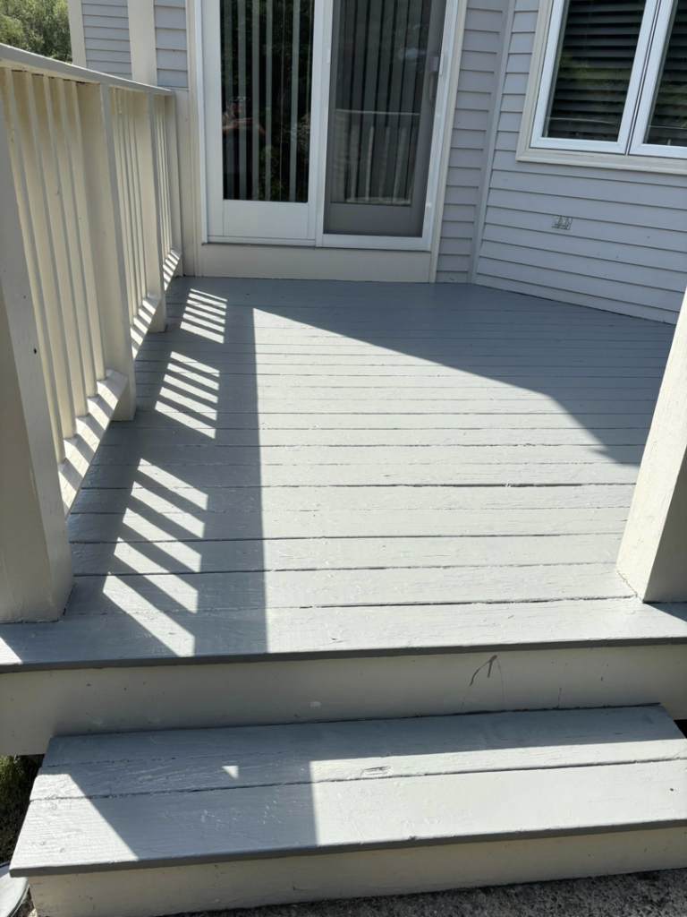 A freshly painted grey outdoor deck and stairs completed by SGT. Handyman services RI in Downtown Pawtucket, RI