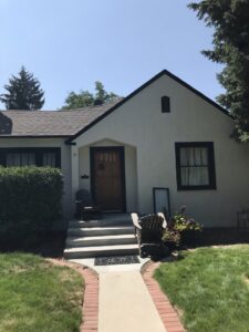 A freshly painted house exterior with dark trim, showcasing painting services by FES handyman services LLC in Boise, ID.